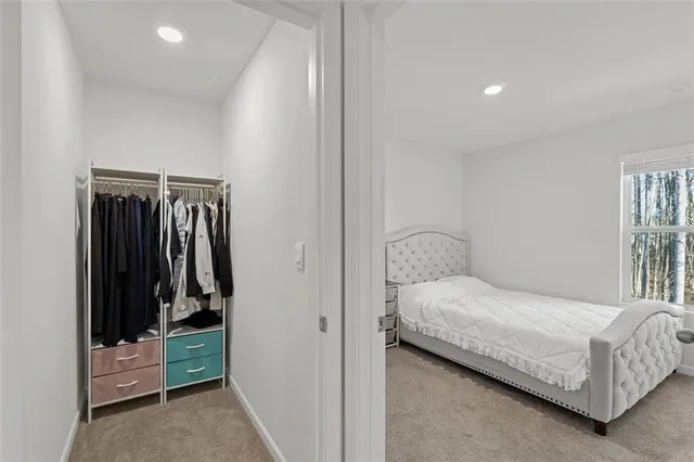 a bedroom with a bed and a walk in closet