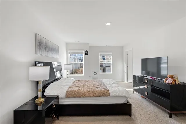 a bedroom with a bed and a flat screen tv