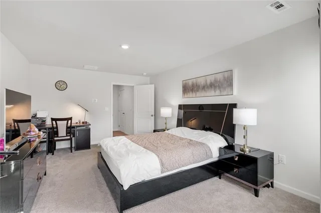 a bedroom with a bed and lamp