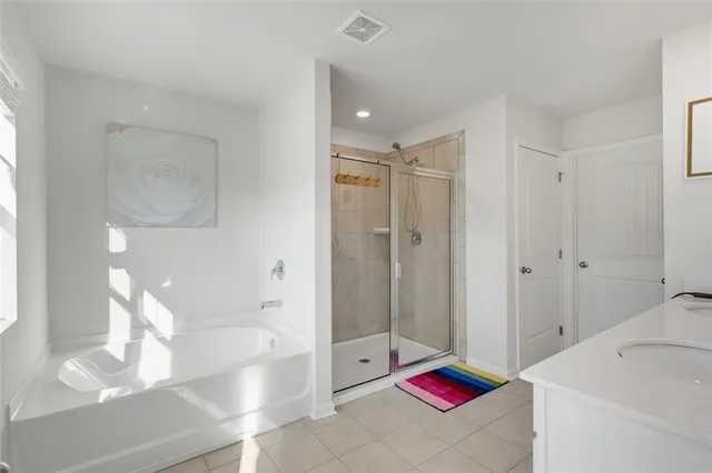 a bathroom with a bath tub and shower