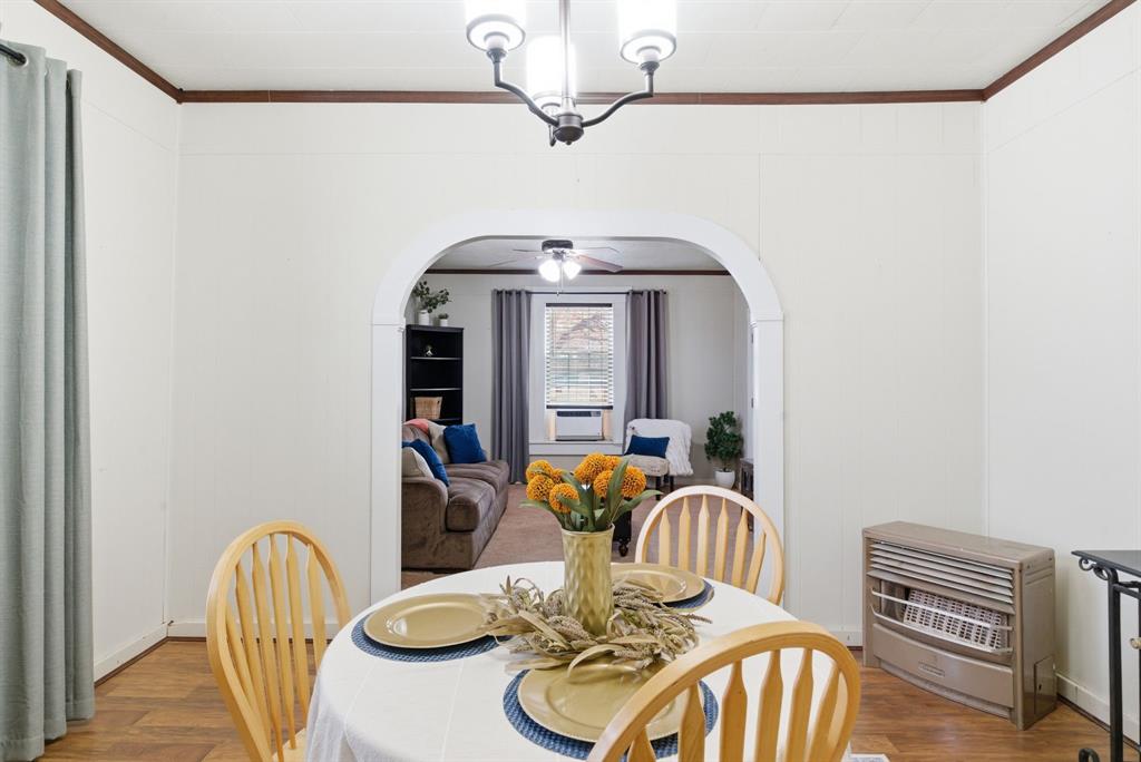 902 North Travis Street De Leon, TX 76444 - Photo 13 of 34 a dining room with furniture and wooden floor