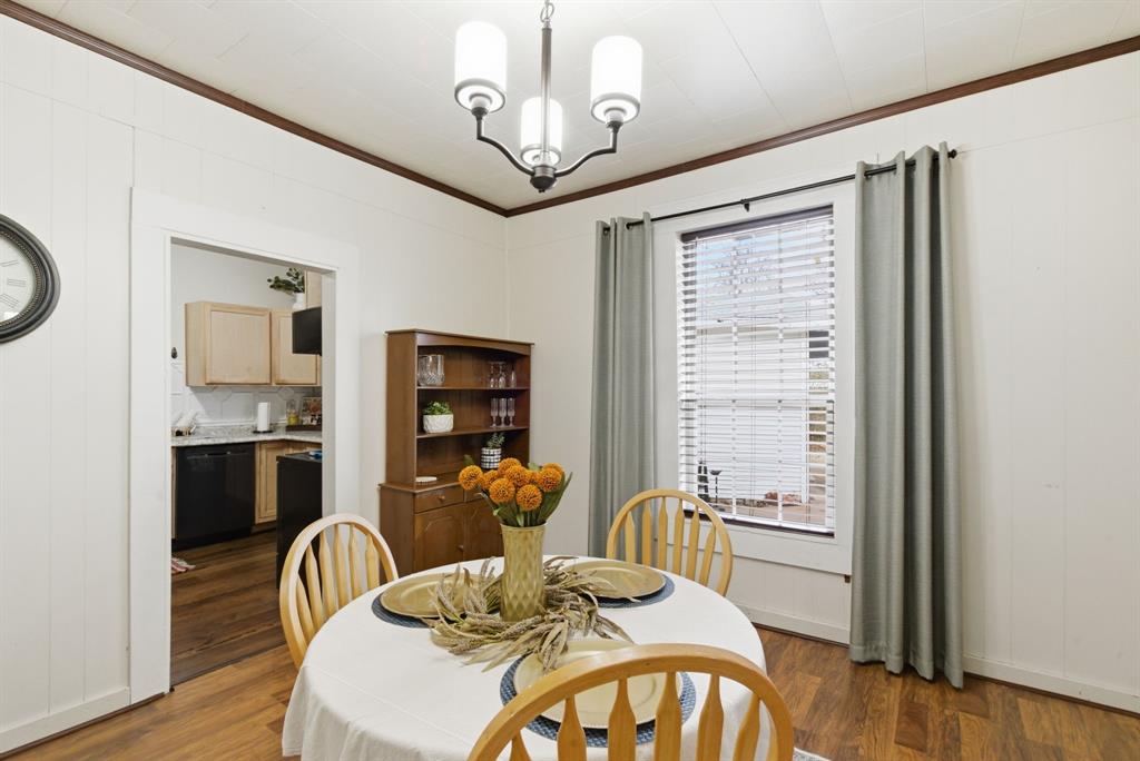 902 North Travis Street De Leon, TX 76444 - Photo 14 of 34 a view of a dining room with furniture window and wooden floor