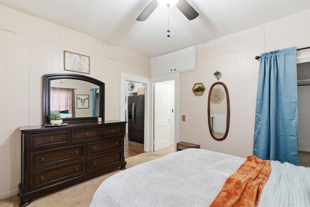 902 North Travis Street De Leon, TX 76444 - Photo 17 of 34 a bedroom with a bed and a mirror on dresser