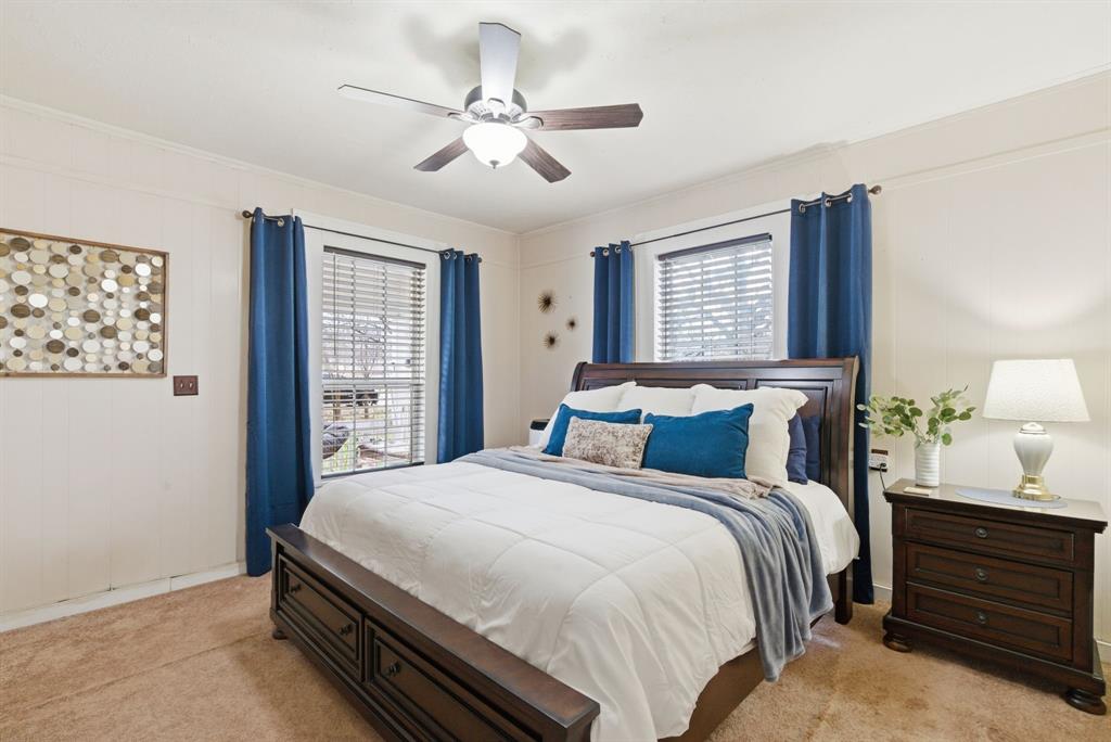 902 North Travis Street De Leon, TX 76444 - Photo 20 of 34 a bedroom with a bed chandelier and a window