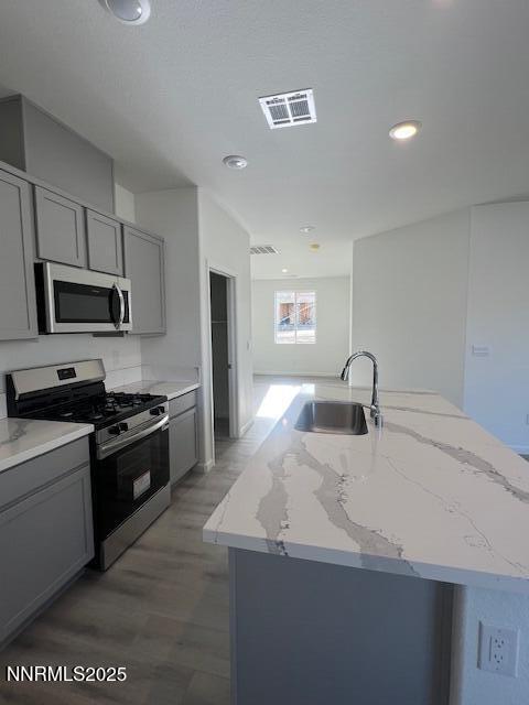 760 Kess Way, Unit LOT 86 Reno, NV 89506 - Photo 9 of 14 a kitchen with kitchen island granite countertop a sink stove top oven and refrigerator