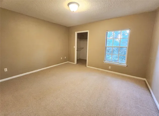 a view of a room with wooden floor and a window