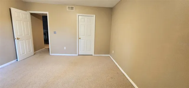 a view of empty room with floor to ceiling window