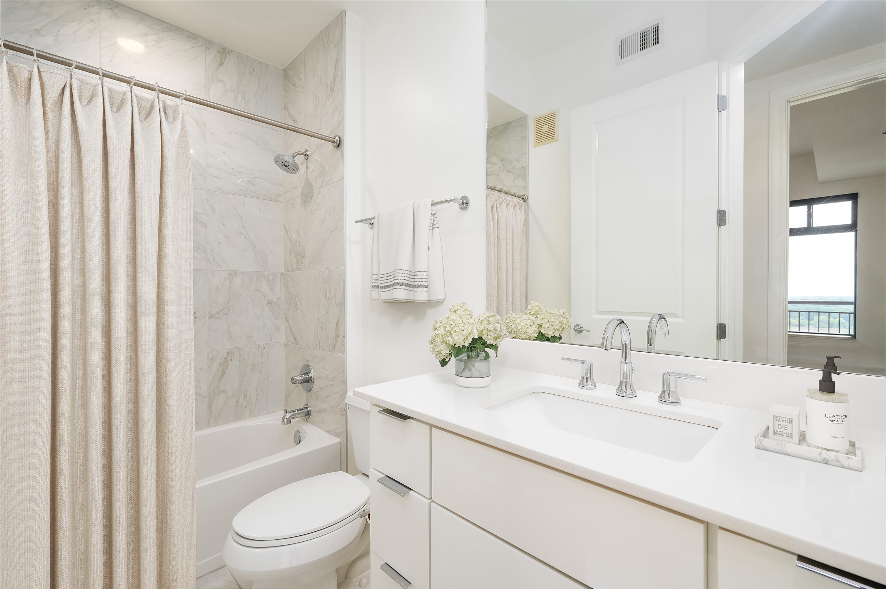 717 Riverside Drive, Unit 1108 Memphis, TN 38103 - Photo 8 of 39 a bathroom with a sink a toilet and shower