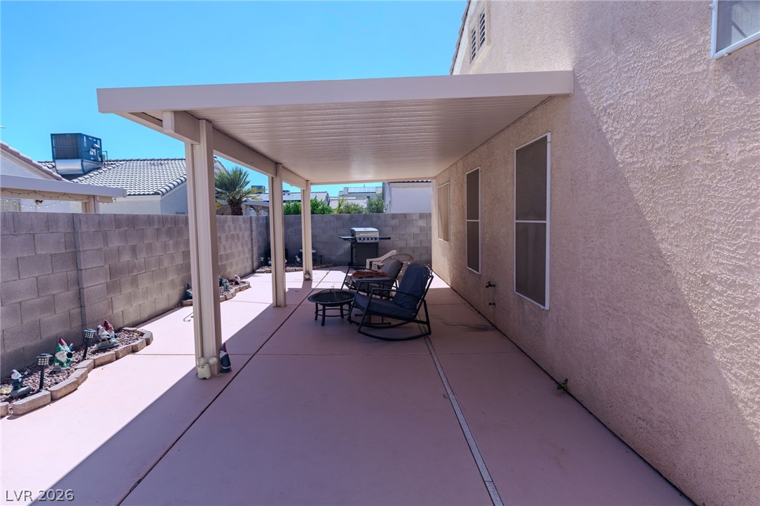 4994 Mascaro Drive Las Vegas, NV 89122 - Photo 22 of 30 An inviting covered patio offers a comfortable outdoor living space for relaxation and entertaining.
