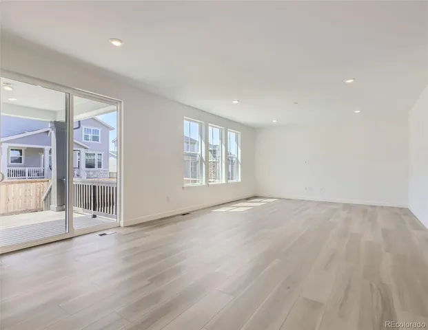a view of an empty room with glass door