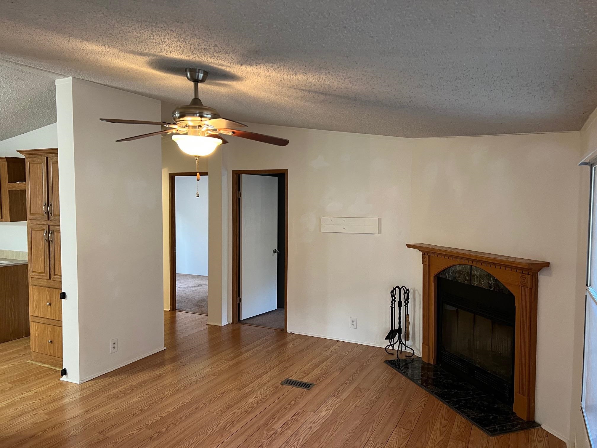 2274 Culps Bend Road Clifton, TN 38425 - Photo 5 of 22 wooden floor in an empty room with a fireplace