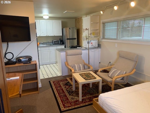 2840 Ferry Street Eugene, OR 97405 - Photo 32 of 35 a kitchen with stainless steel appliances kitchen island granite countertop a stove a sink and a microwave