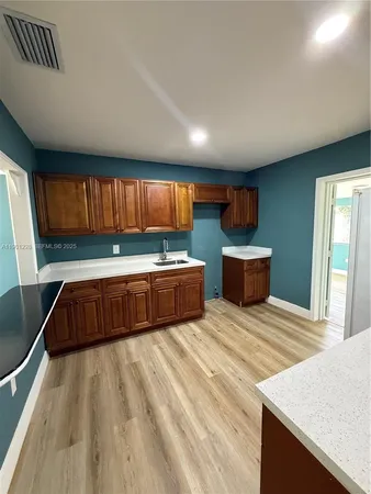 a kitchen with stainless steel appliances kitchen island a large island in the center