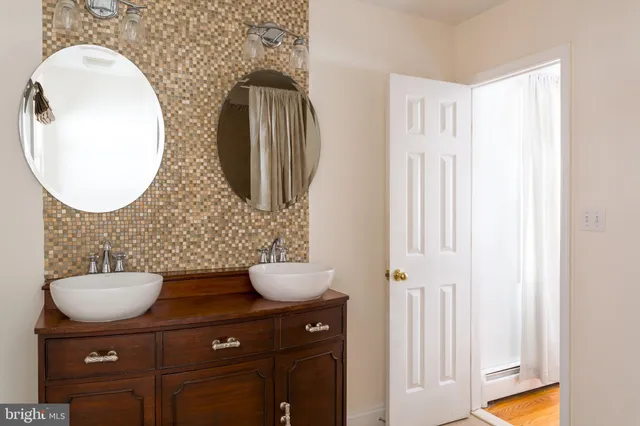 a bathroom with a toilet mirror and vanity