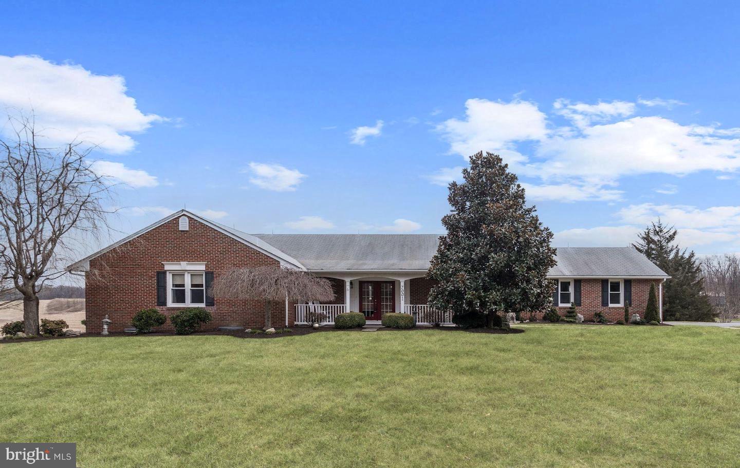 7001 Watersville Road Mount Airy, MD 21771 - Photo 2 of 3 a front view of a house with a garden