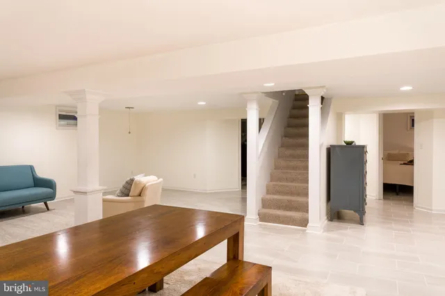 a living room with furniture and white wooden floor
