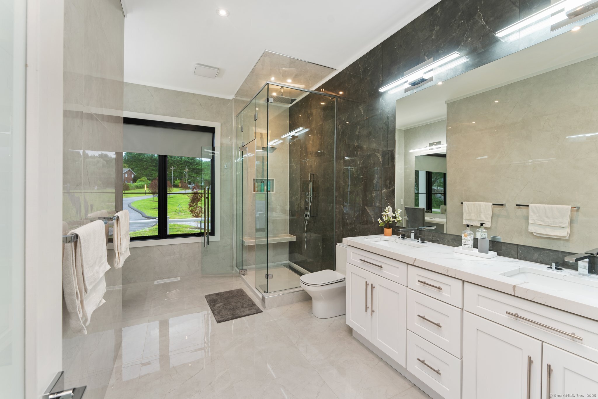 Undisclosed Address Norwich, CT 06360 - Photo 11 of 40 a spacious bathroom with a double vanity sink toilet mirror and shower