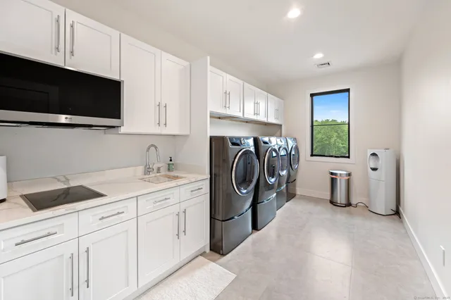 a kitchen with a sink a washer and dryer