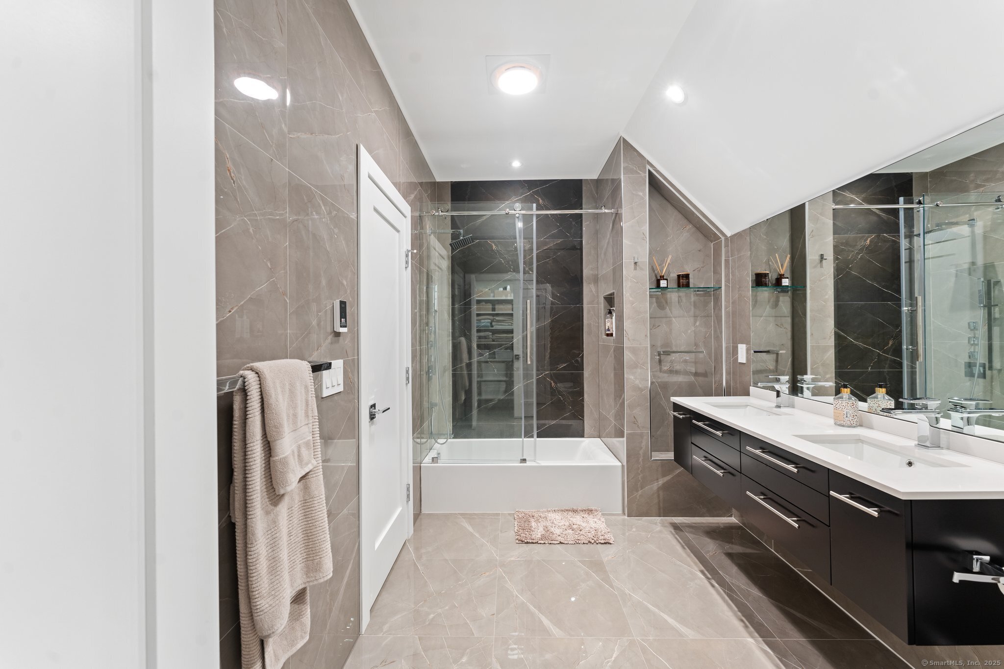 Undisclosed Address Norwich, CT 06360 - Photo 19 of 40 a bathroom with a double vanity sink a large mirror and shower