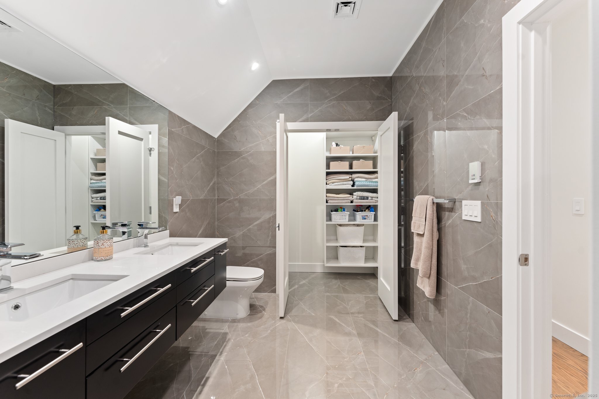 Undisclosed Address Norwich, CT 06360 - Photo 21 of 40 a spacious bathroom with a double vanity sink a toilet and a shower