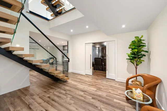 a view of entryway and hall with wooden floor