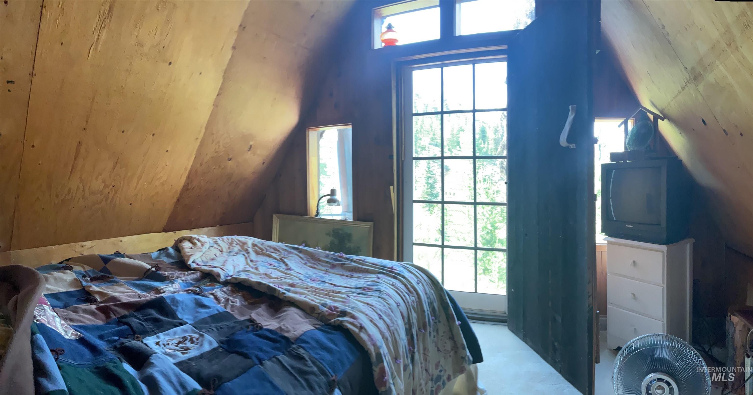 2871 Orogrande-Dixie Road Elk City, ID 83525 - Photo 24 of 40 Attic space featuring sloped wood-paneled walls and a French door with an upper transom window