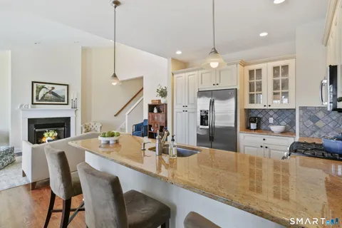 a large kitchen with a table and chairs