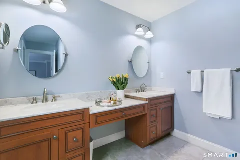a bathroom with a double vanity sink and a mirror