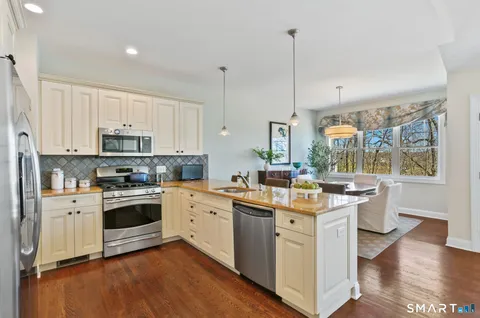 a kitchen with a stove sink and cabinets