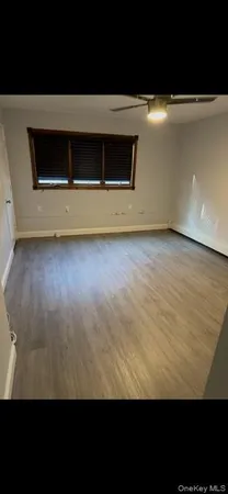 a view of an empty room with a kitchen