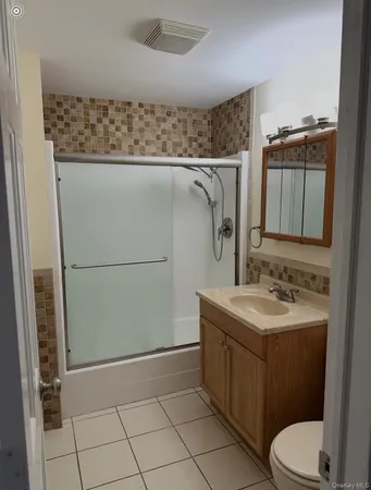 a bathroom with a sink a toilet and mirror