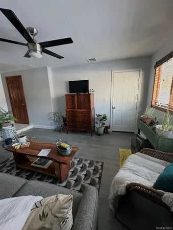 a bedroom with furniture and a window