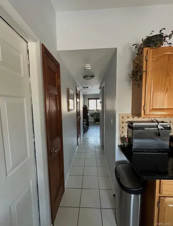 a hallway with a stove a washer and dryer