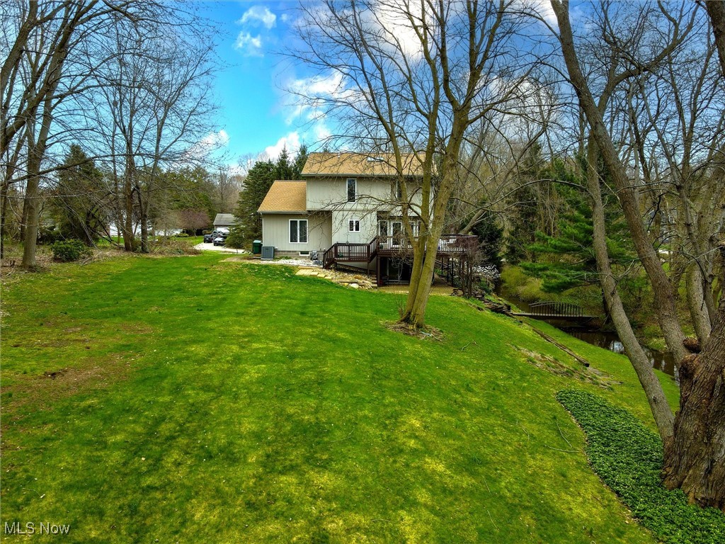 2068 Chimney Ridge Drive Madison, OH 44057 - Photo 33 of 37 View of yard featuring a wooden deck