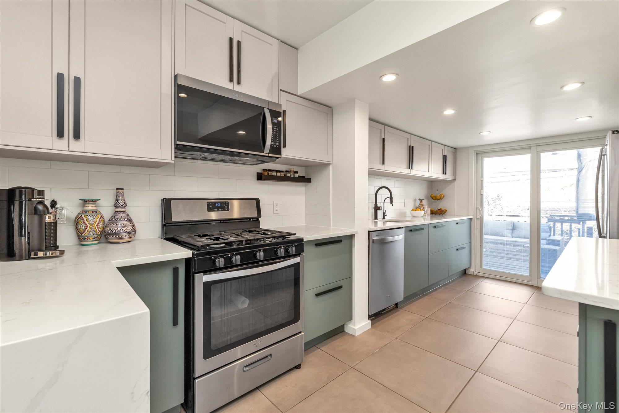 13 Gotham Street Valley Stream, NY 11581 - Photo 7 of 22 a kitchen with stainless steel appliances granite countertop a sink a stove a microwave and cabinets