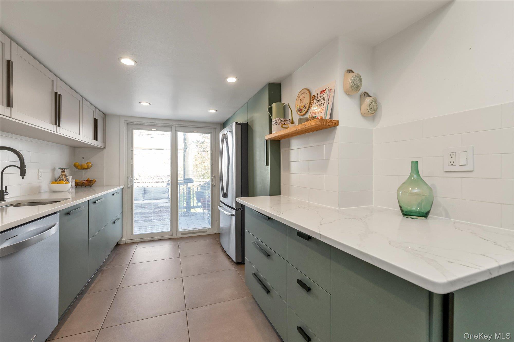 13 Gotham Street Valley Stream, NY 11581 - Photo 8 of 22 a kitchen with a sink and a refrigerator