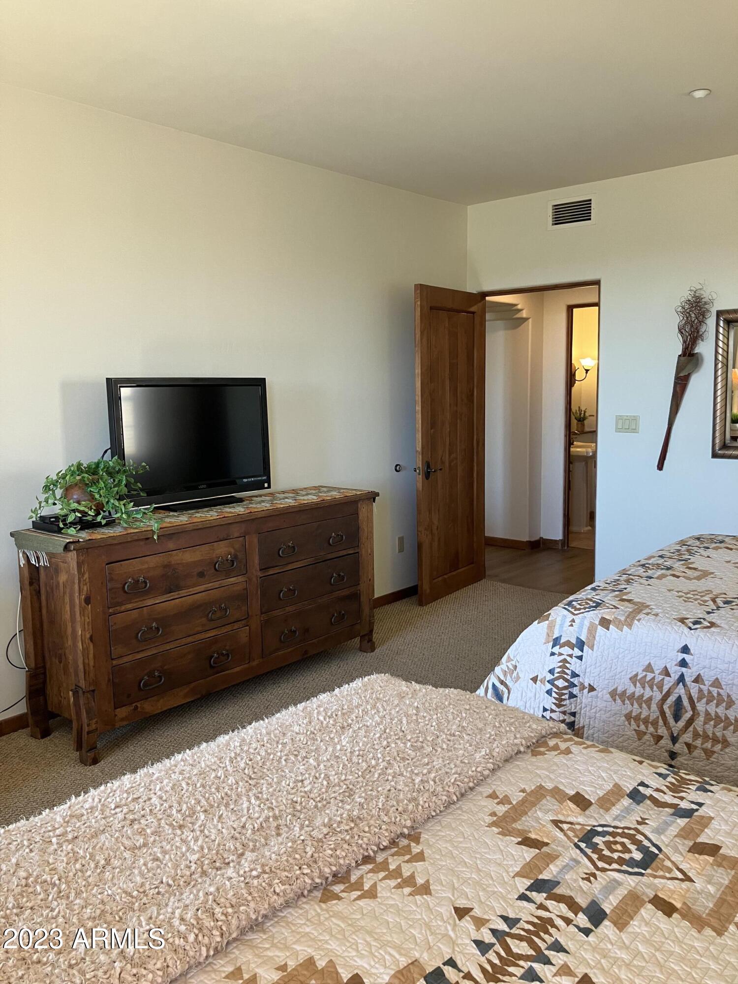 36601 North Mule Train Road, Unit 29C Carefree, AZ 85377 - Photo 13 of 35 a bedroom with a bed and flat screen tv