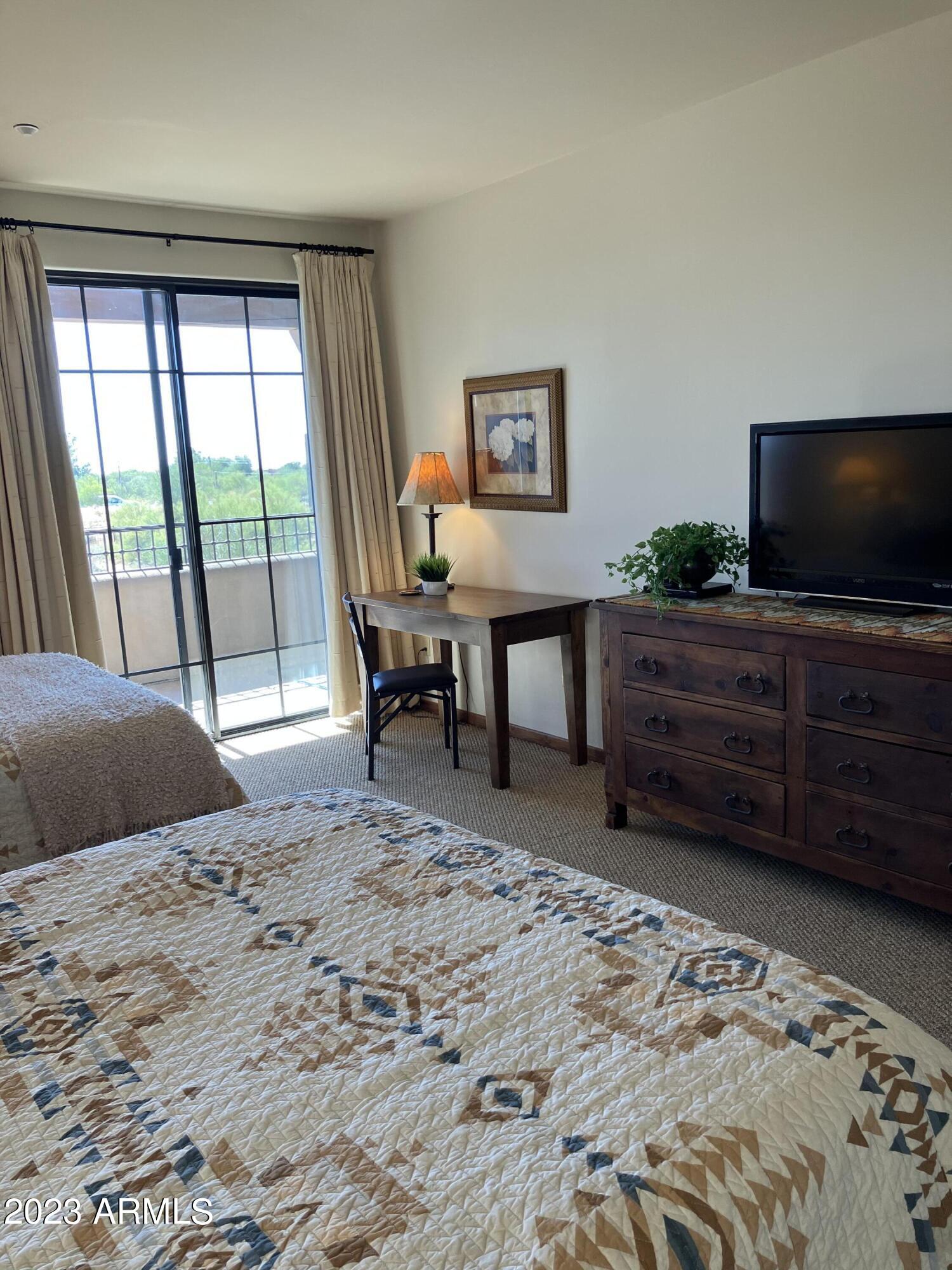36601 North Mule Train Road, Unit 29C Carefree, AZ 85377 - Photo 14 of 35 a view of a bedroom with furniture and flat screen tv