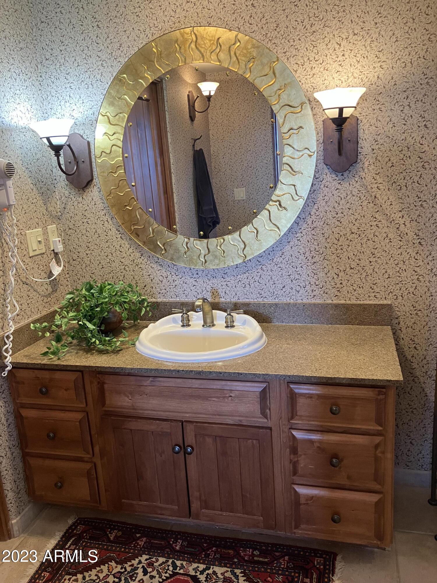 36601 North Mule Train Road, Unit 29C Carefree, AZ 85377 - Photo 16 of 35 a bathroom with a sink and a mirror