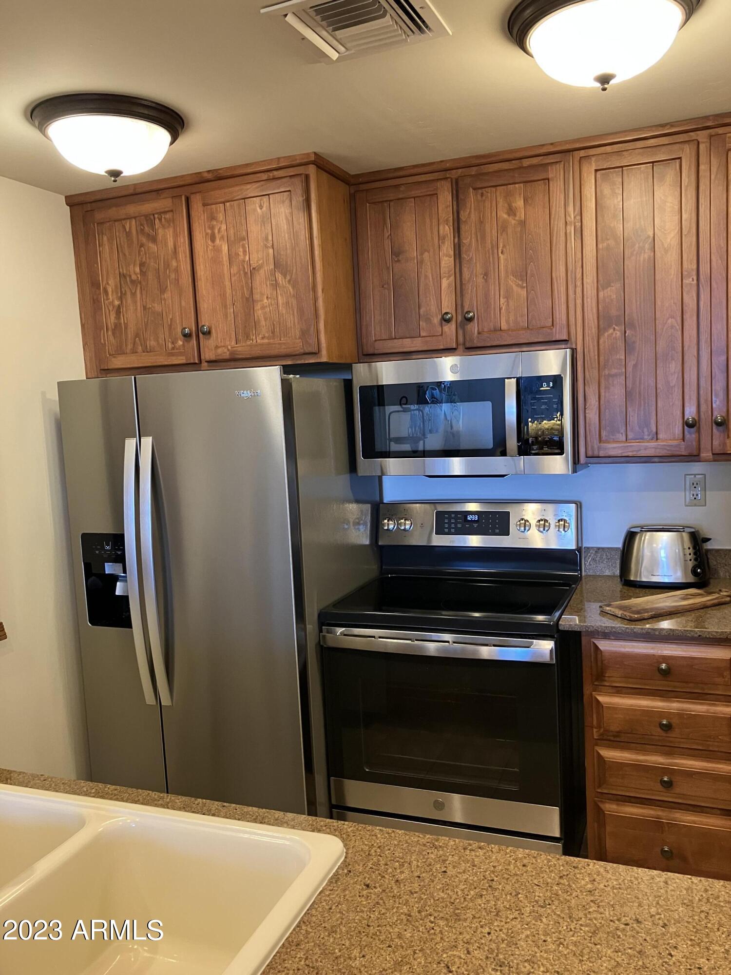 36601 North Mule Train Road, Unit 29C Carefree, AZ 85377 - Photo 2 of 35 a kitchen with appliances and cabinets