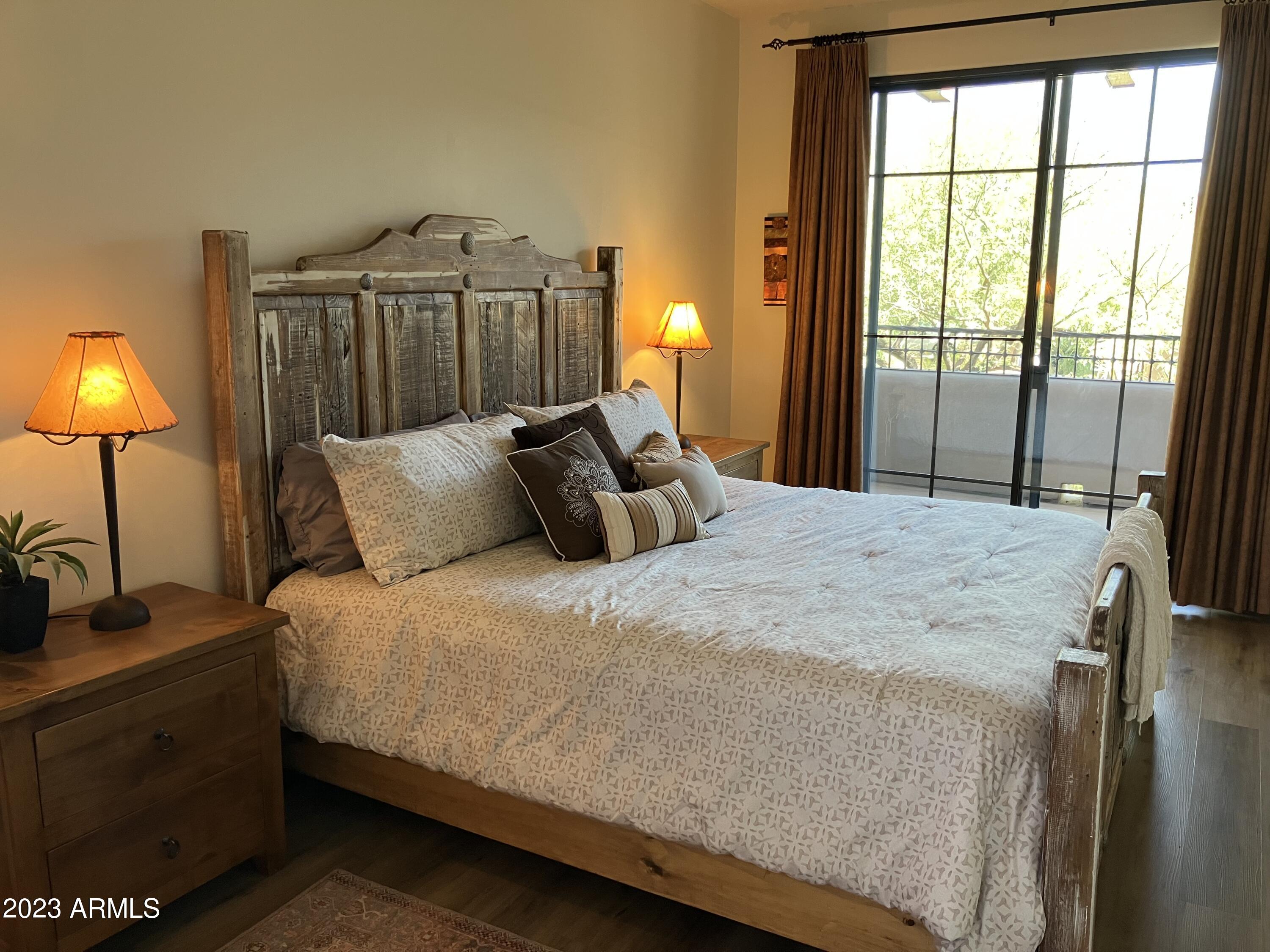36601 North Mule Train Road, Unit 29C Carefree, AZ 85377 - Photo 23 of 35 a bedroom with a bed and a lamp