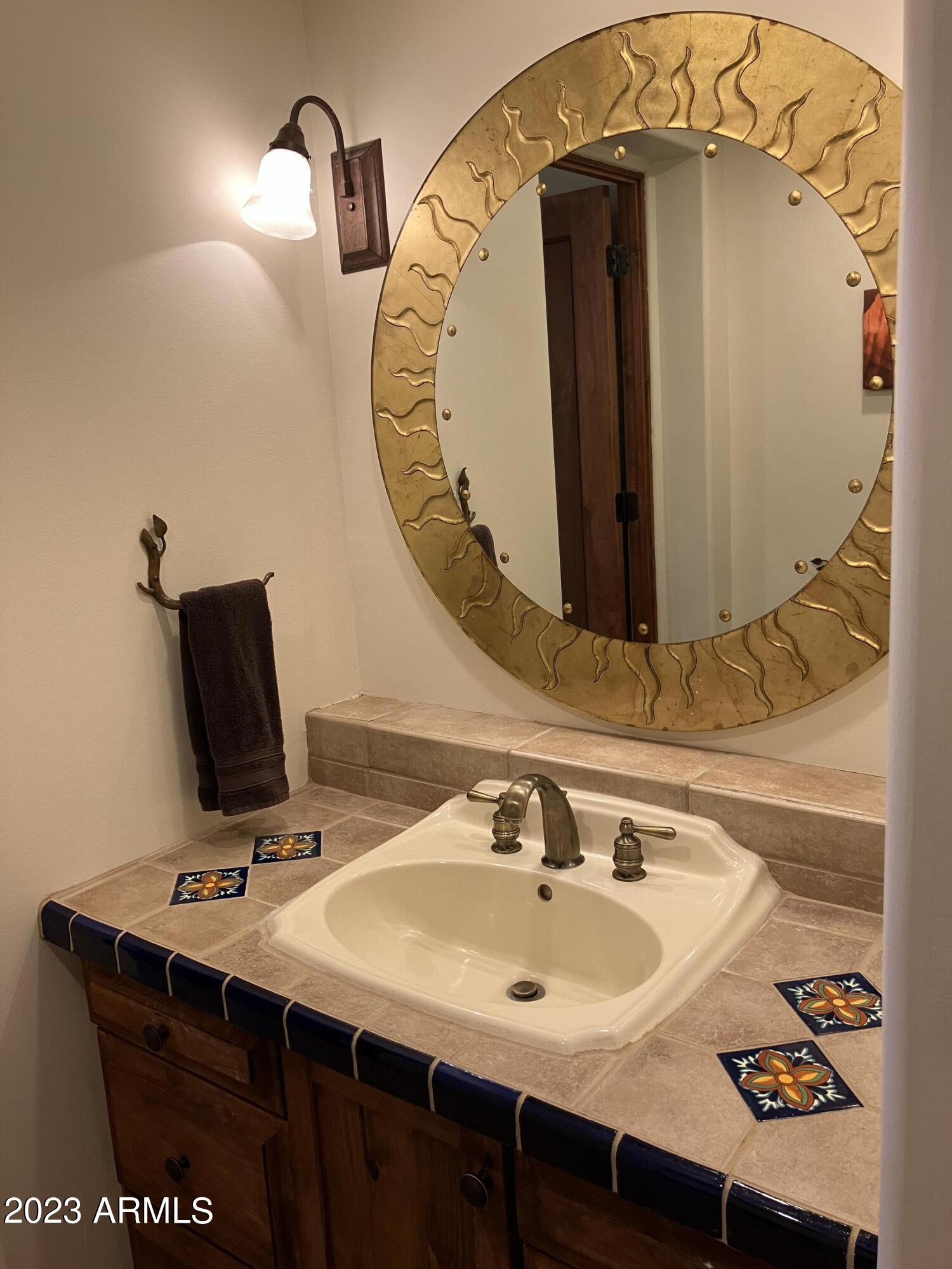 36601 North Mule Train Road, Unit 29C Carefree, AZ 85377 - Photo 24 of 35 a bathroom with a sink and mirror