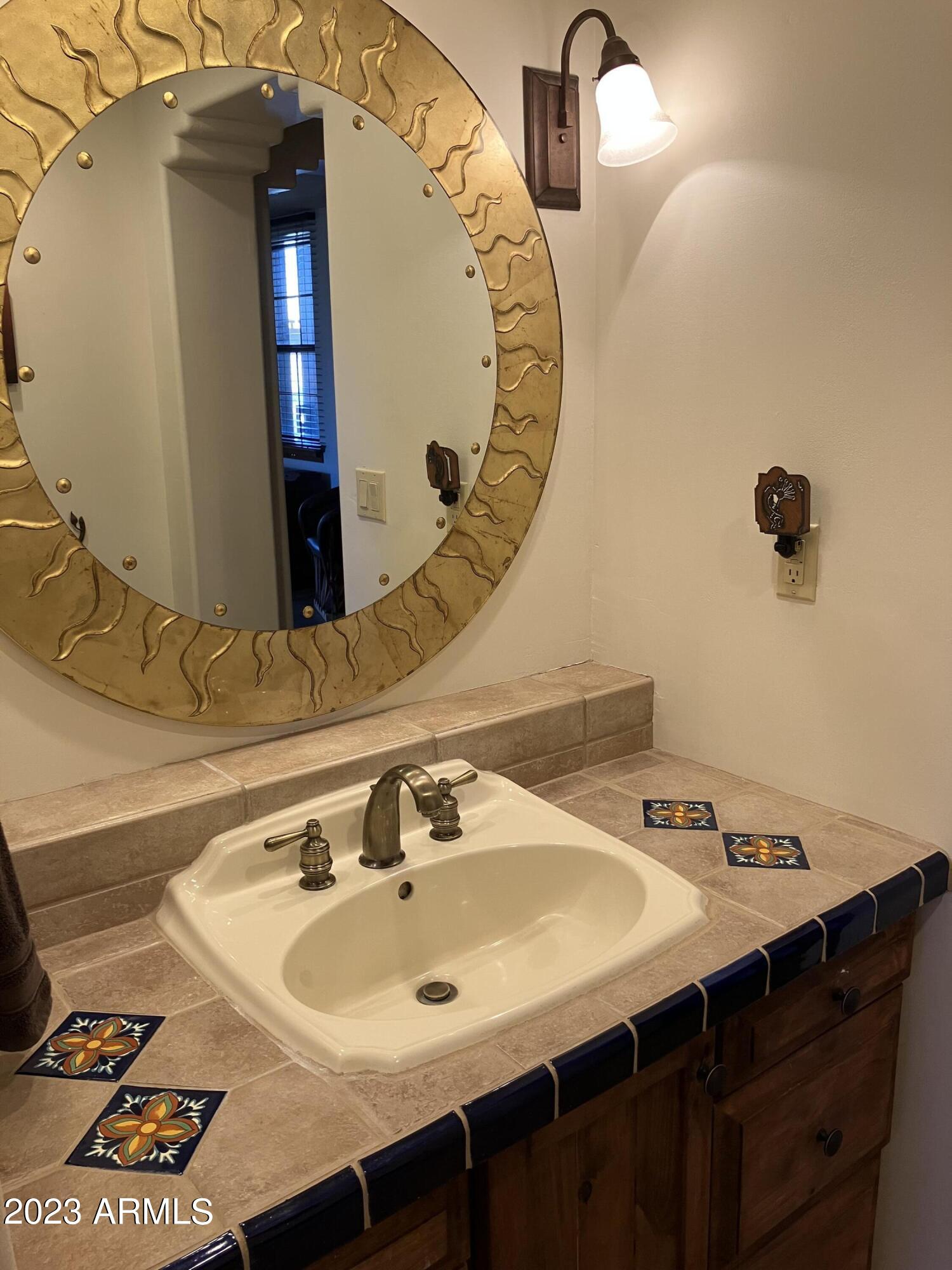 36601 North Mule Train Road, Unit 29C Carefree, AZ 85377 - Photo 25 of 35 a bathroom with a sink and a mirror