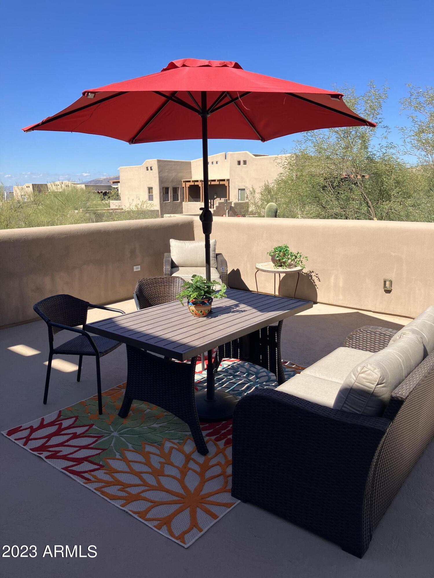 36601 North Mule Train Road, Unit 29C Carefree, AZ 85377 - Photo 29 of 35 a view of table and chairs under an umbrella