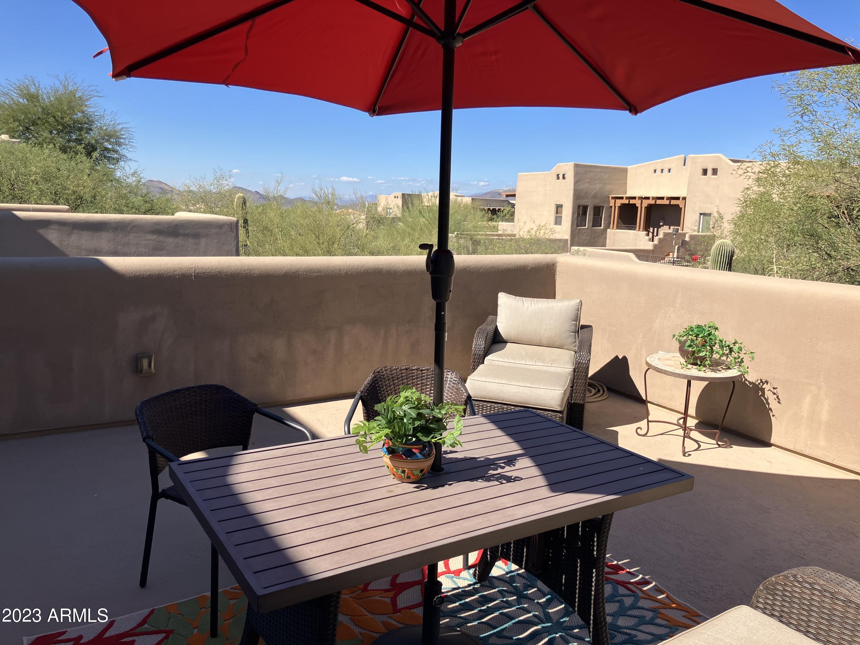 36601 North Mule Train Road, Unit 29C Carefree, AZ 85377 - Photo 30 of 35 a view of a patio with furniture and a table
