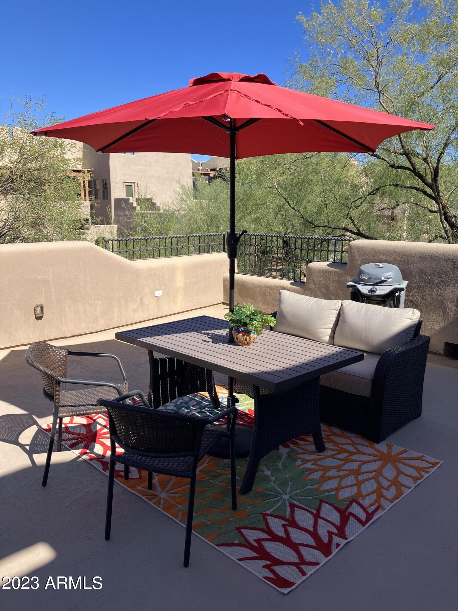 36601 North Mule Train Road, Unit 29C Carefree, AZ 85377 - Photo 31 of 35 a view of a patio with a table chairs and a table