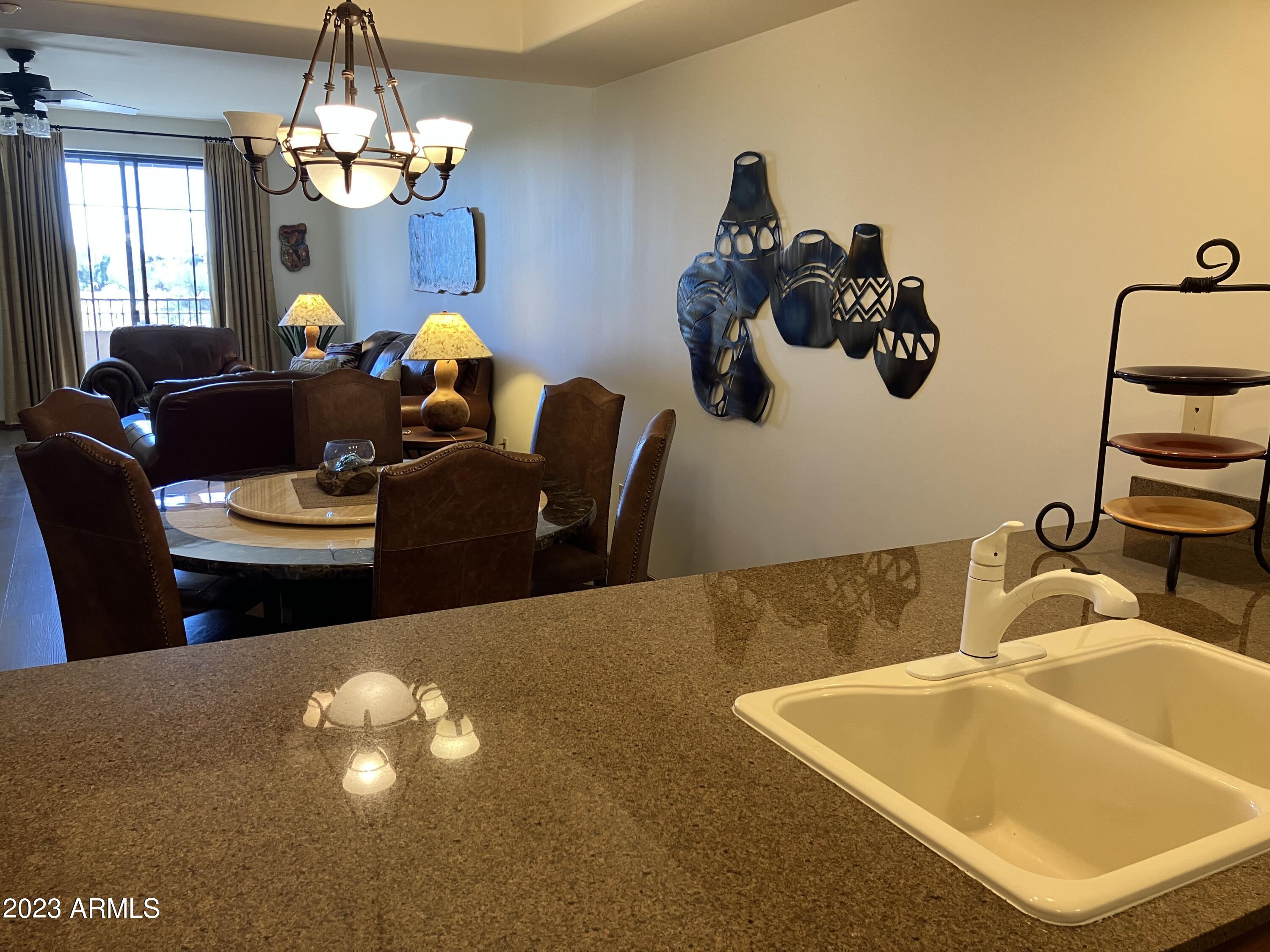 36601 North Mule Train Road, Unit 29C Carefree, AZ 85377 - Photo 7 of 35 a living room with dining table and chairs