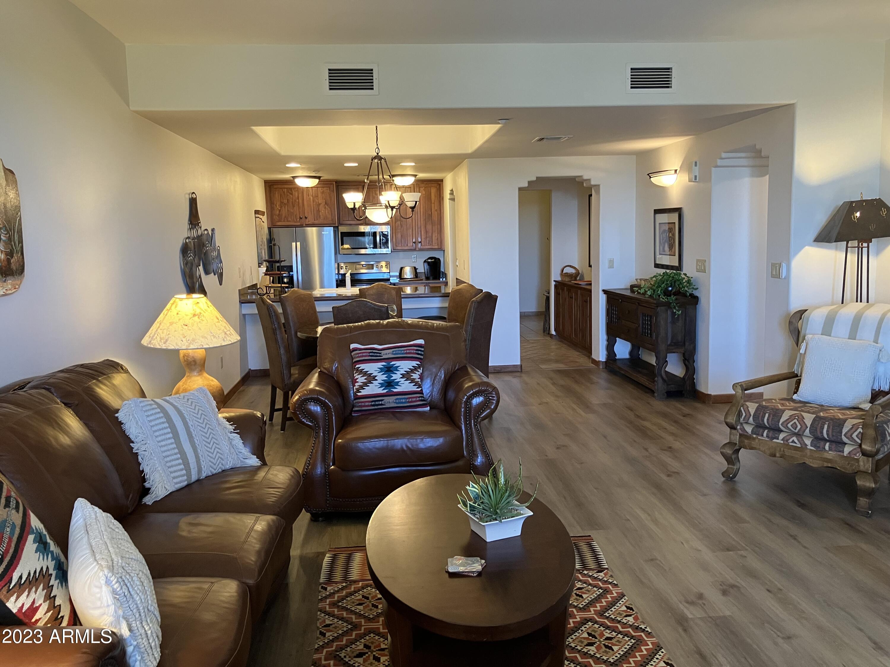 36601 North Mule Train Road, Unit 29C Carefree, AZ 85377 - Photo 8 of 35 a living room with furniture and a wooden floor