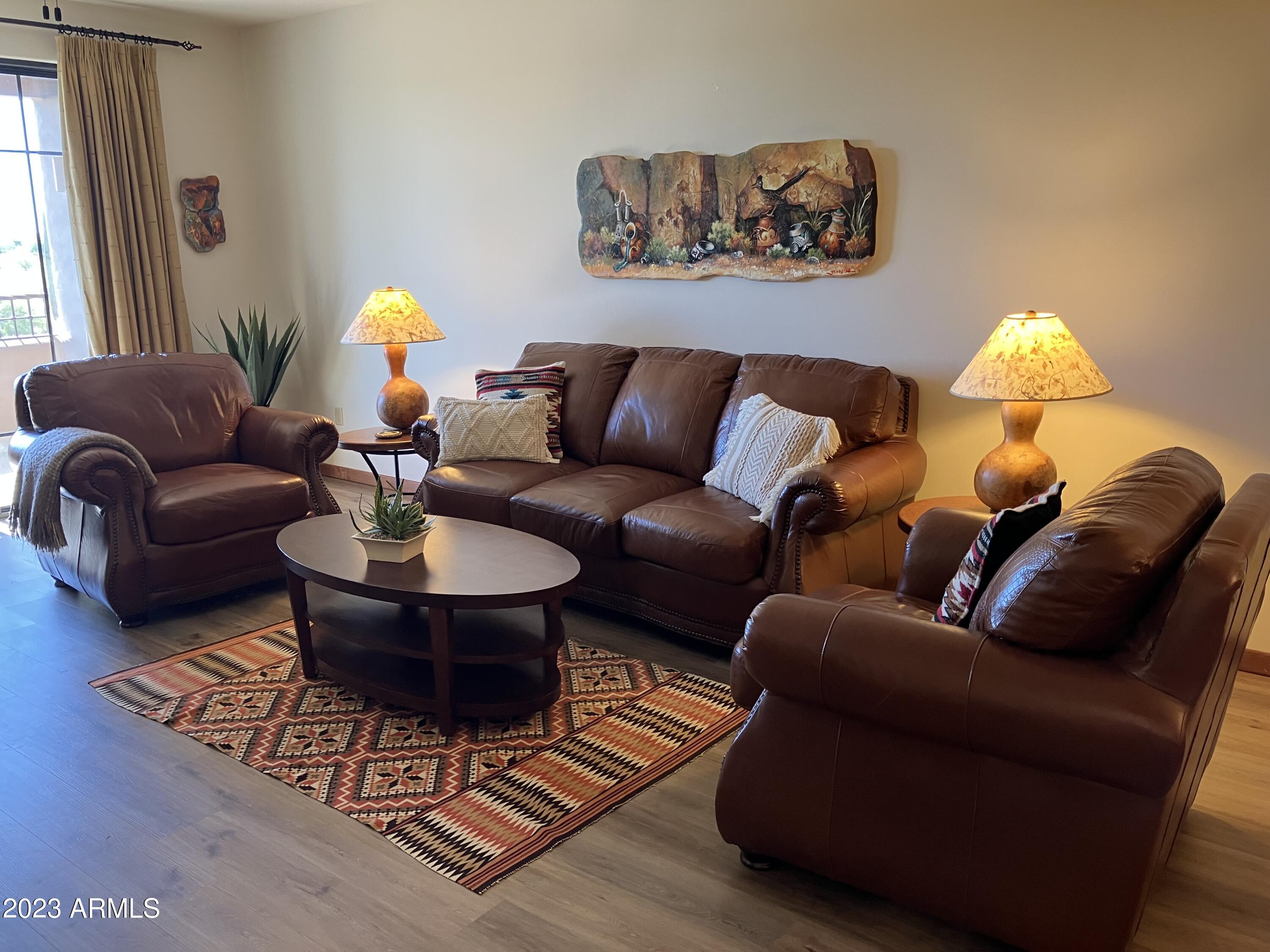 36601 North Mule Train Road, Unit 29C Carefree, AZ 85377 - Photo 9 of 35 a living room with furniture and a lamp