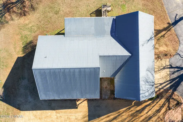 a front view of a house with a yard covered in snow
